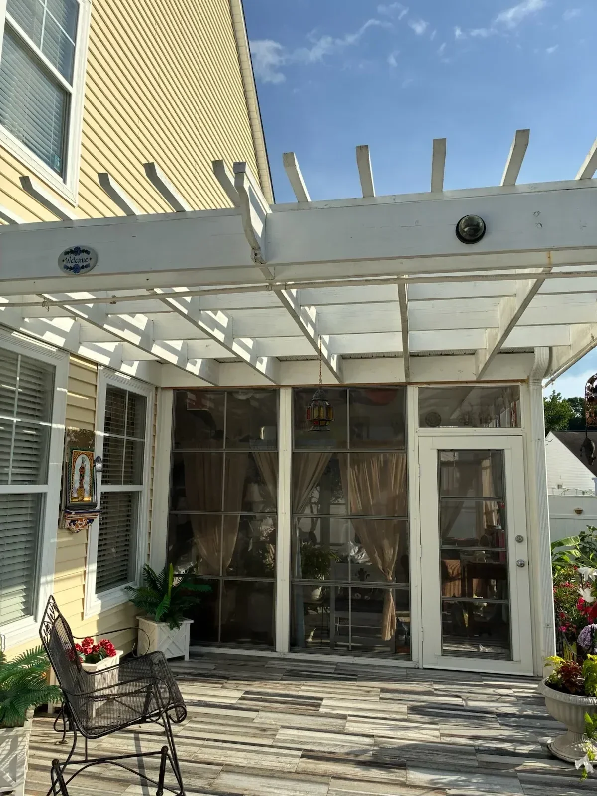 Metal horizontal railing with aluminum pickets on multi-level deck with corrugated metal flooring