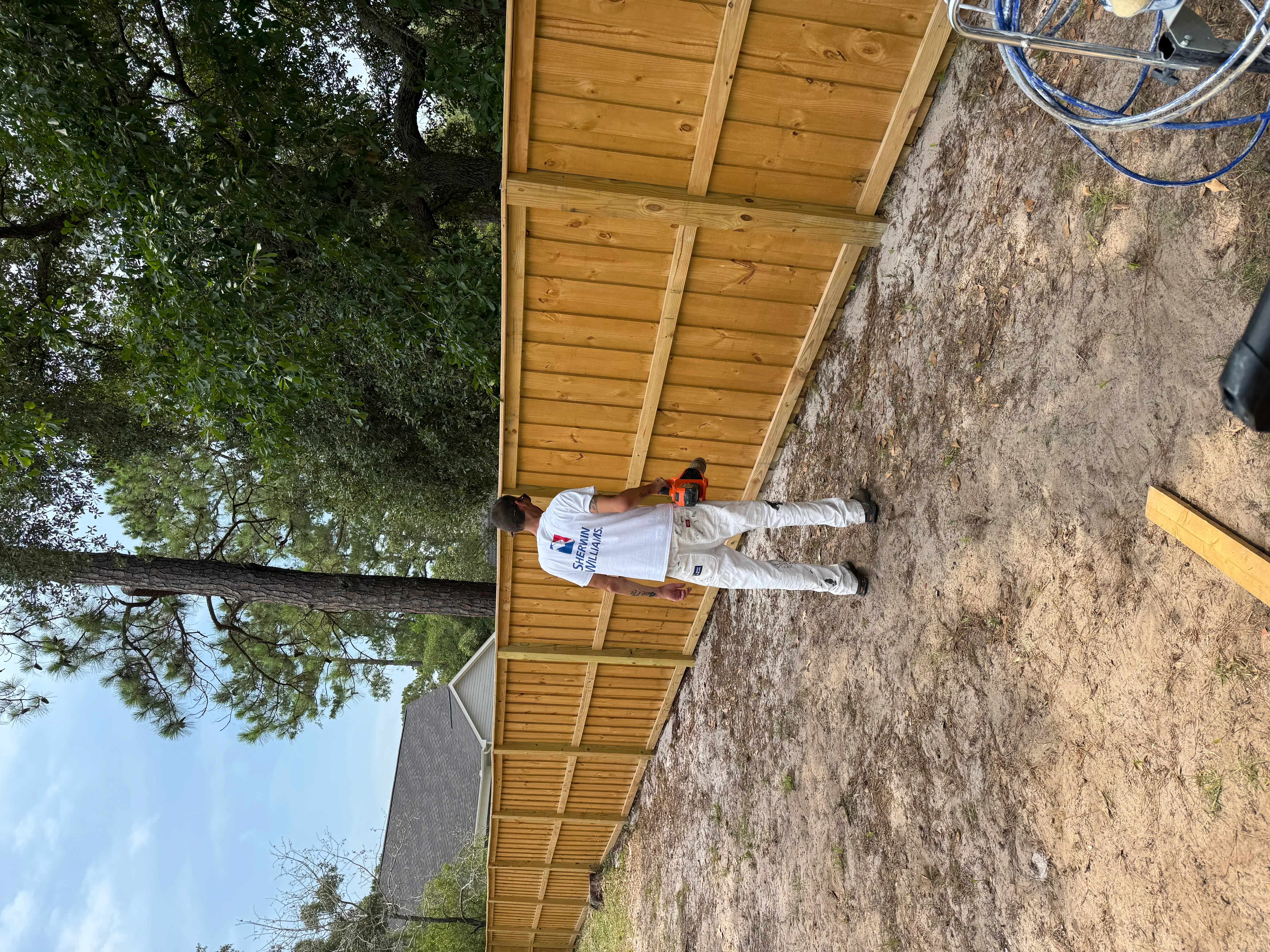 Wooden pergola with horizontal beams and pressure-treated lumber construction
