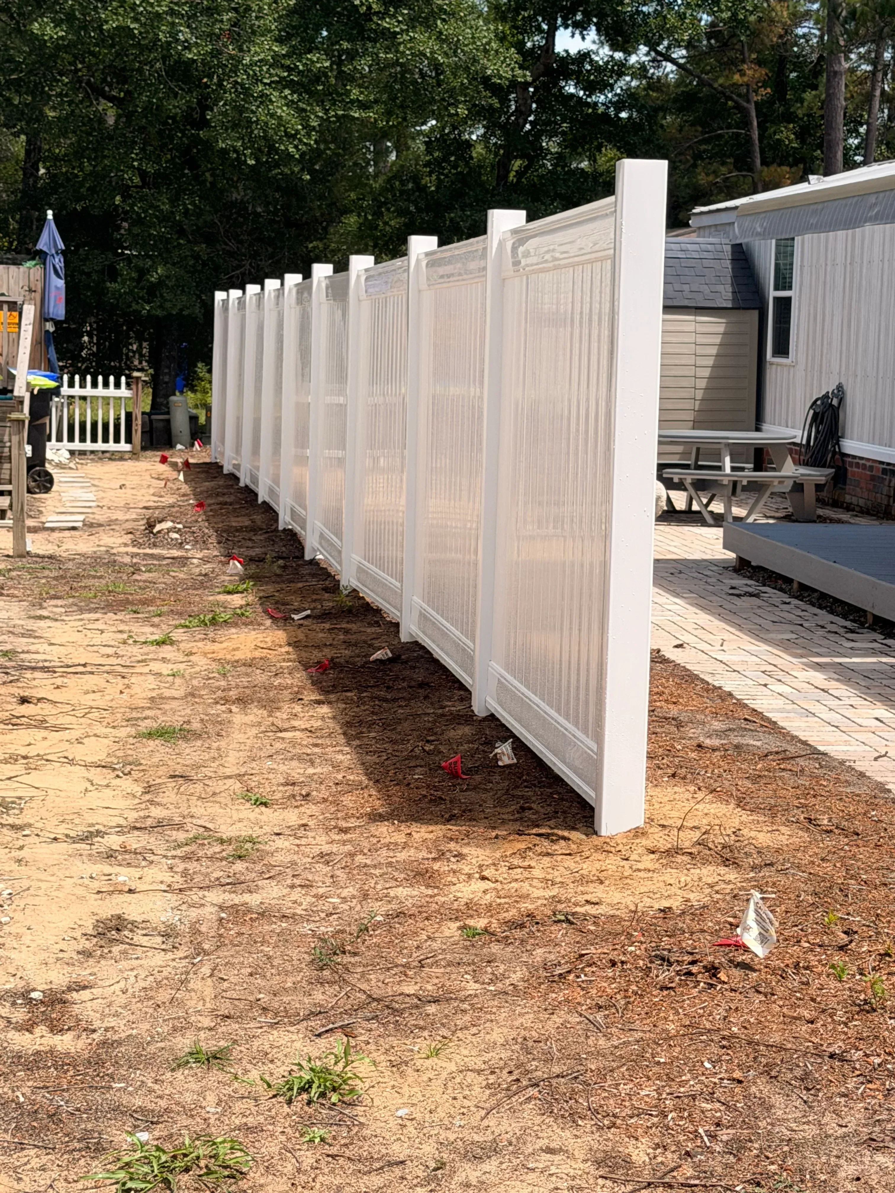 White polycarbonate patio cover with aluminum frame over residential driveway