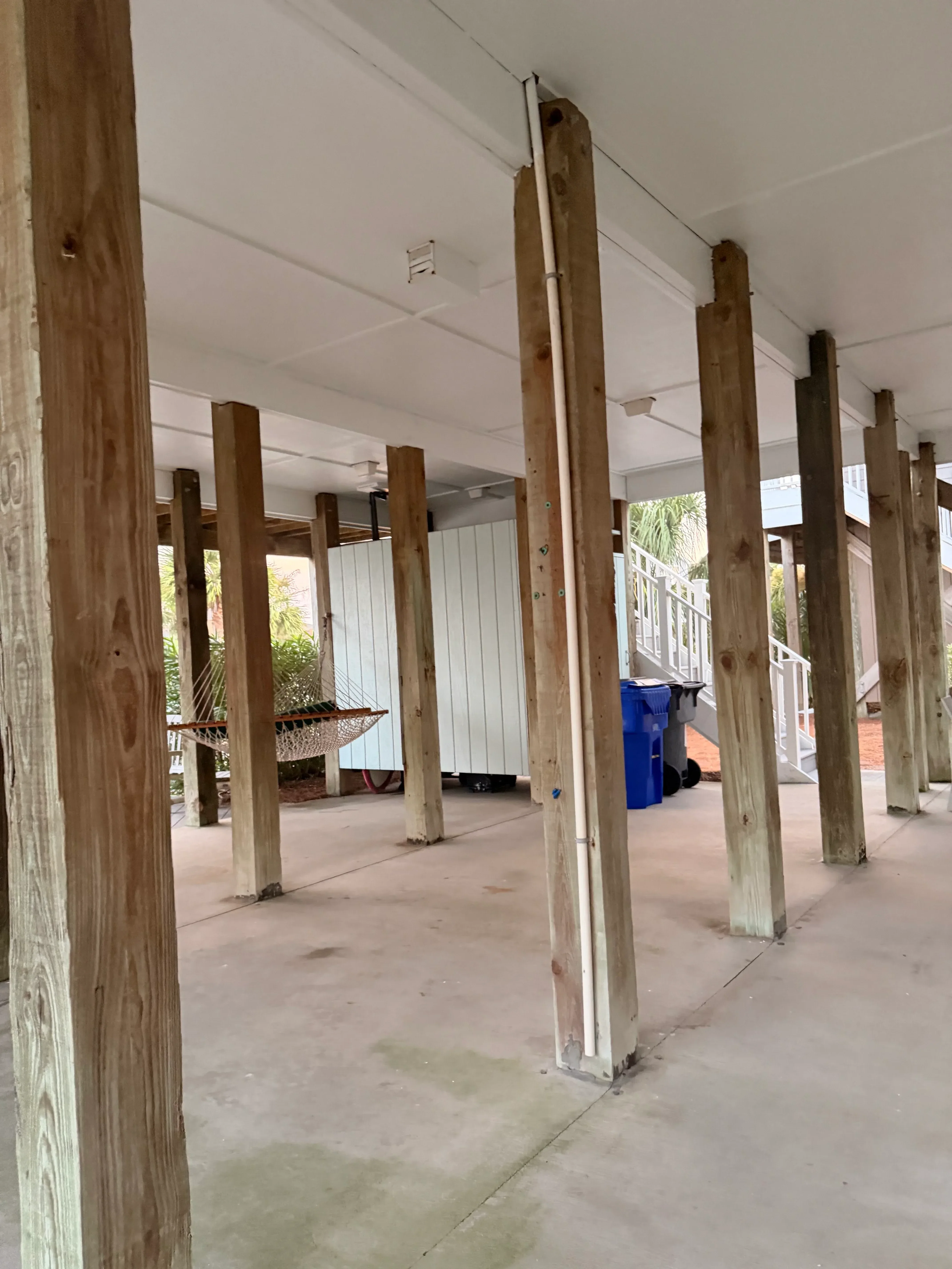 Pressure-treated lumber deck frame with beams and joists during construction phase
