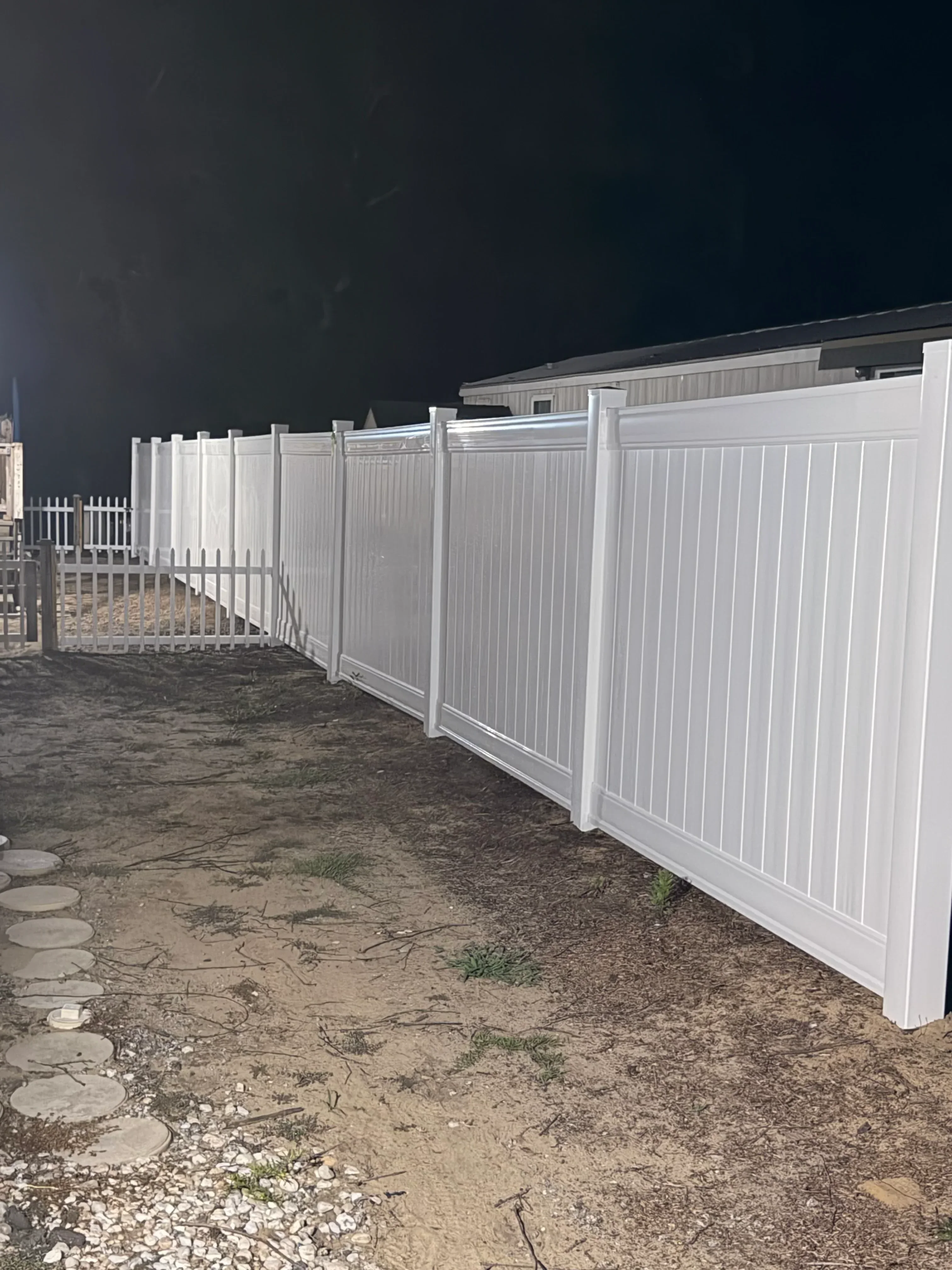 White aluminum patio cover with horizontal slats over concrete patio